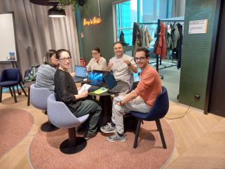 Eine Gruppe von 5 Personen sitzt an einem Tisch