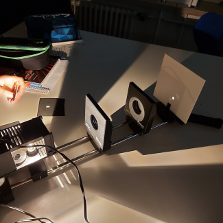 Versuchsaufbau mit einem Licht und Blenden auf einer Schiene